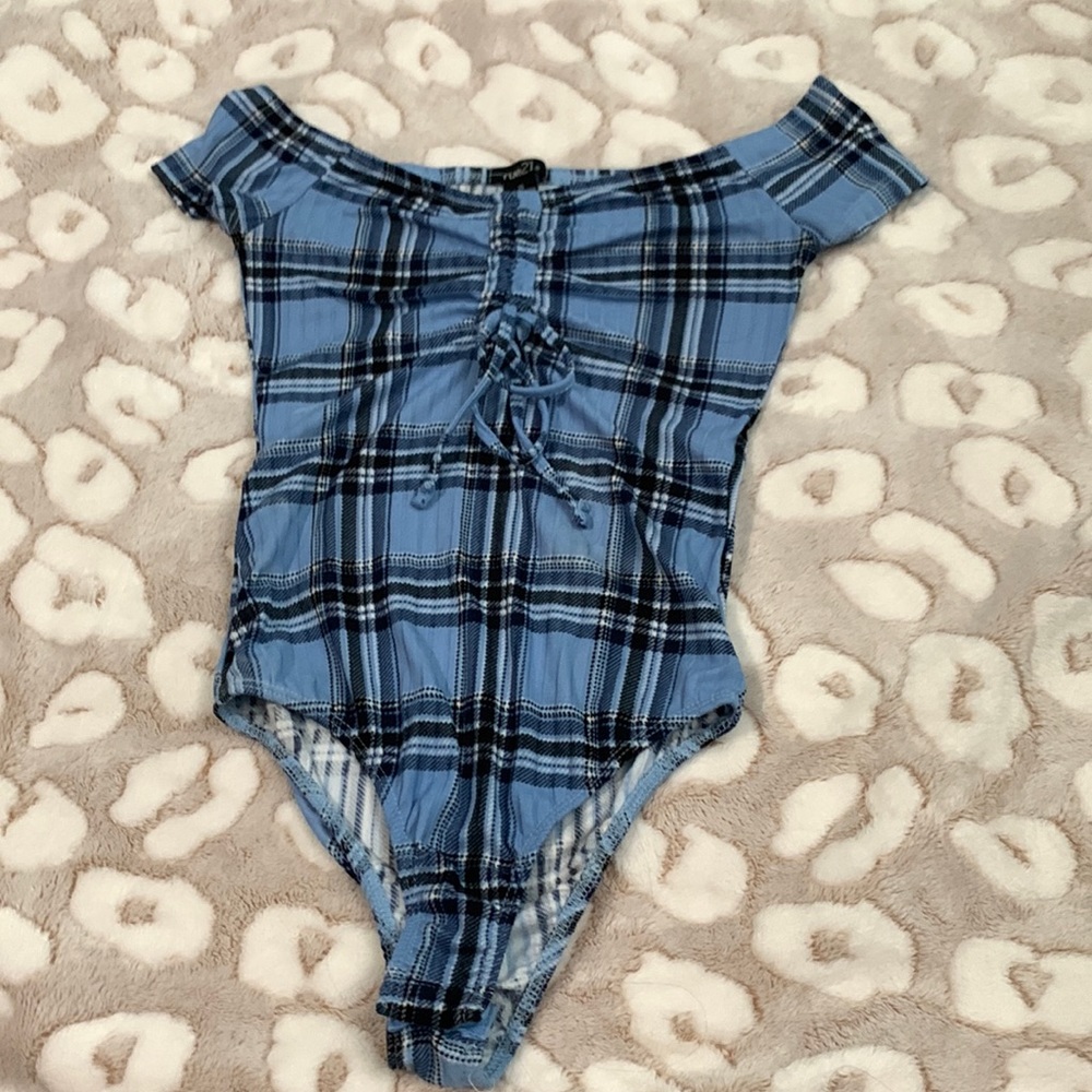 Plaid rue21 off the shoulders bodysuit. it singes towards the cleavage area.